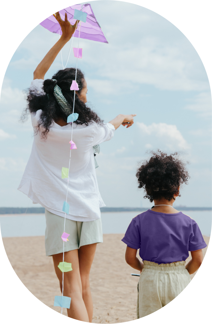 Kids preparing to fly a kite on a beach